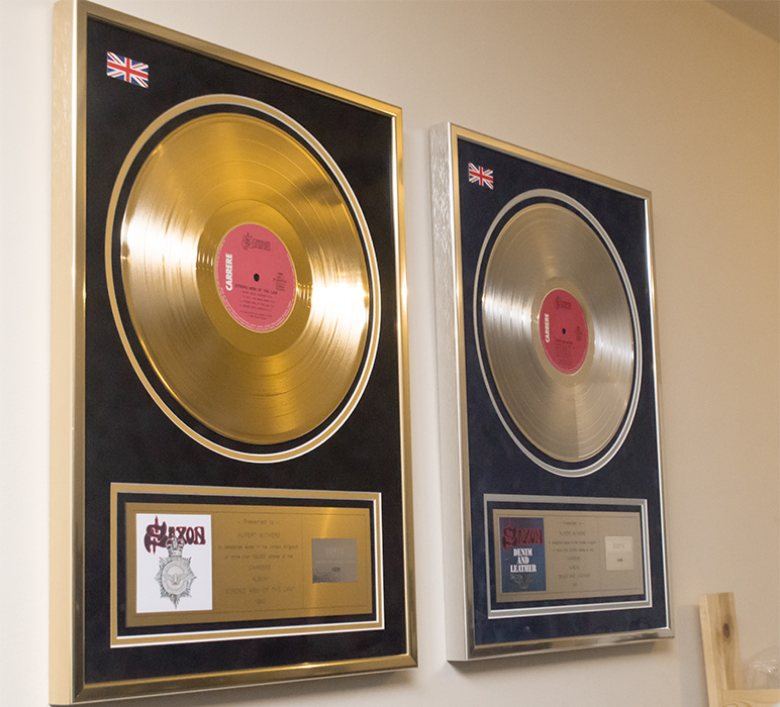 Framed gold and silver disc awards from Rupert Withers’ music management work